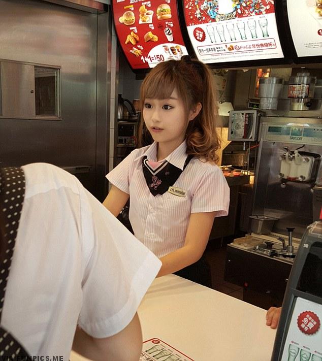 Pic shows: Woman Hsu Wei-han working at the front counter of a McDonalds restaurant. A young woman working at the front counter of a McDonalds restaurant has become the latest overnight celebrity of working-class folk after she was discovered by a blogger. The woman known as Hsu Wei-han, whose age was not given, was spotted working at a McDonalds restaurant in the city of Kaohsiung, in southern Taiwan, by an avid blogger known as RainDog. RainDog noted on his blog that Wei-han, who is also known as "Weiwei" or "Haitun" ("dolphin" in Chinese), was cute and wore a pink shirt and heels. His blog post rocketed Weiwei to Internet fame almost overnight. She has been called the "cutest McDonalds goddess in Taiwanese history", after netizens pointed out that McDonalds chains in the country were actually famous for dressing up their female employees in cute themed outfits, such as sailors or maids. Netizens in Kaohsiung are now scrambling to find out which branch she works at in hopes of getting a peek at the McDonalds Goddess. Other popular working-class beauties and "hunks" from Taiwan included fruit, tofu, and cake vendors in capital Taipei, as well as a girl who became known affectionately as the "Pork Princess". Some people however accused the blogger of manipulating the pictures and claiming the woman did not exist, even though several local media outlets republished the images of the girl with abnormally large eyes and doll-like features as a news story with no suggestion she was not real. (ends)