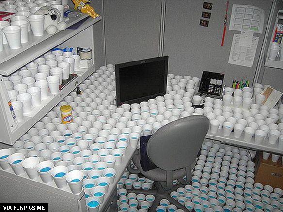 Blocking access to colleague’s desk with filled water cups